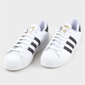Adidas Superstar ADV White Sneakers with Black Stripes and Gold Accents